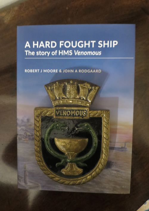 Crest of HMS Venomous on top  of book cover