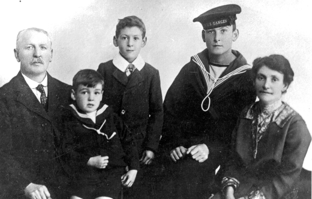 Reginal Williams with the cap ribbon of HMS Ganges with his family