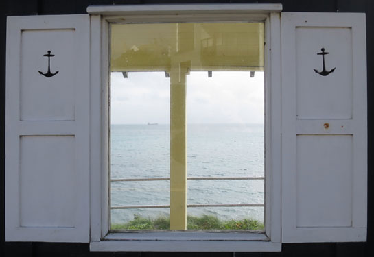 Window of bus shelter outside Memblay Hotel